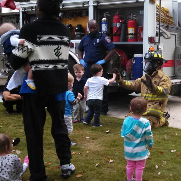 Children interacting with CIty of Decatur firefighters last fall